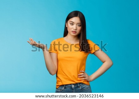 Ignorant bossy asian woman high-standarts, look dismay arrogant, act snobbish complaining bad service, raise hand full disbelief, cannot stand nonsense, stand annoyed blue background Royalty-Free Stock Photo #2036523146