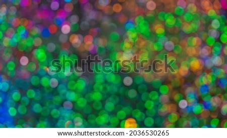 Christmas lights. Festive New Year blurred pink, purple and black background. Beautiful sparkling backdrop, texture.