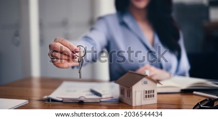 Real estate or broker residential or Agent showing key for house and car rent Royalty-Free Stock Photo #2036544434