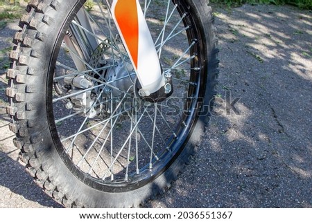 The front fork and wheel of a sports motorcycle. Close-up.