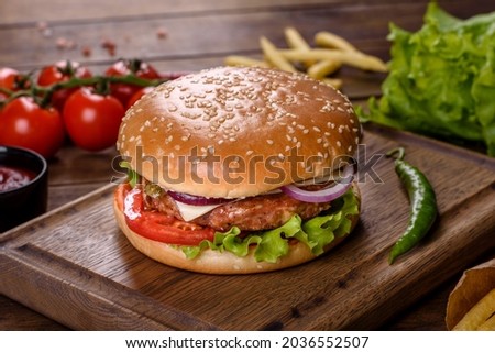 Delicious fresh homemade burger on a dark table