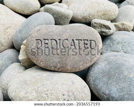 Dedicated Text Carved Into Stone Royalty-Free Stock Photo #2036557193