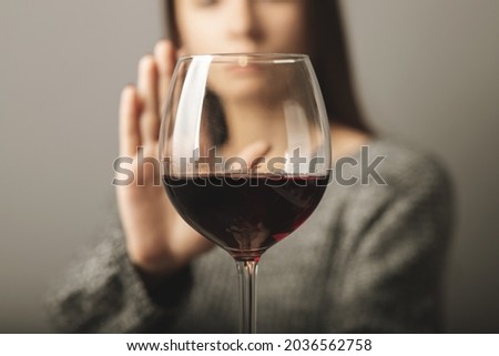 reject liquor,stop alcohol, teenager girl shows a sign of refusal of wine Royalty-Free Stock Photo #2036562758