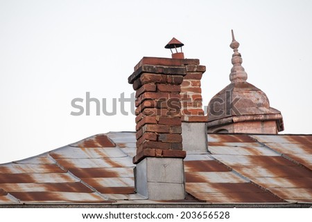 Roof and chimney from an old house - brick and metallic texture