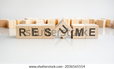 brand - word of wooden blocks with letters on a gray background. Reflection of the caption on the mirrored surface of the table. Selective focus.