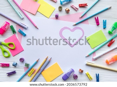 Frame of different stationery on white wooden background, flat lay with space for text. Back to school