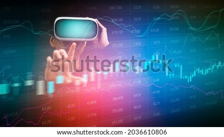 man wearing virtual reality goggles VR and touch line of Stock market or forex trading graph and candlestick chart suitable for financial investment concept,Economy trends background 