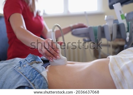 Doctor conducting ultrasound examination of pelvic organs to patient in clinic closeup Royalty-Free Stock Photo #2036637068