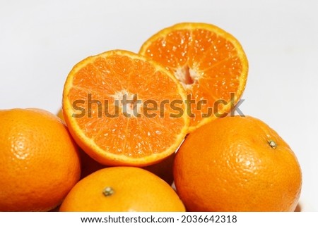 Cross section of mandarin orange fruit on white background. Health benefits of fresh oranges are excellent sources of vitamin C.