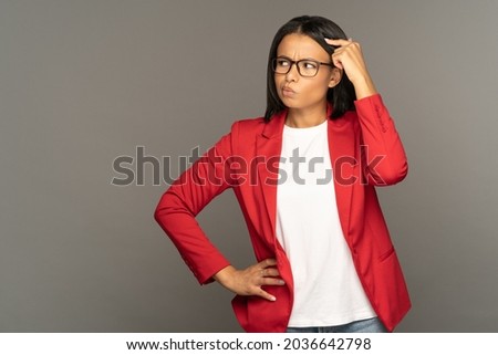 Confused thoughtful businesswoman of mix race rubbing head looking side at copy space. Young successful business lady entrepreneur finding solution, best decision for investment, idea of development Royalty-Free Stock Photo #2036642798