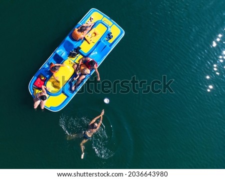 pedalo with people playing on the lake  Royalty-Free Stock Photo #2036643980