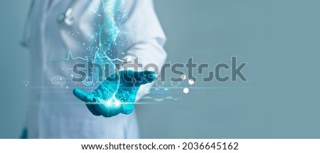 Medicine doctor holding blue helix DNA structure on hologram modern virtual screen interface and diagnose  healthcare on digital network, Science, Medical technology and futuristic concept.  Royalty-Free Stock Photo #2036645162