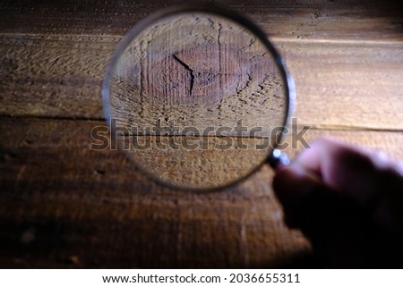 Magnifying glass on wooden table.