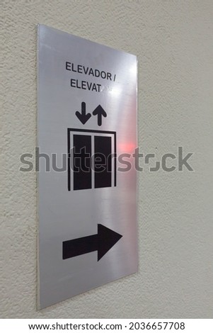 metal elevator signage, on wall