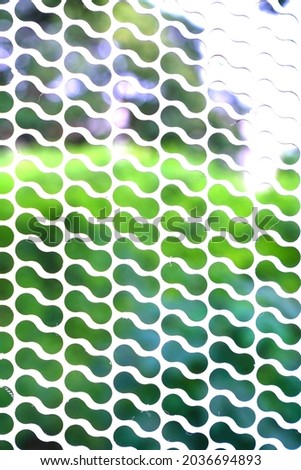    white iron grille on green and white background                            