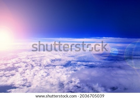 Sunrise in the stratosphere above the clouds. Flying above the clouds in the morning sunlight. Royalty-Free Stock Photo #2036705039