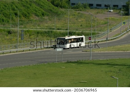 White passenger bus on a country road on a summer day. Passenger transportation by road. Royalty-Free Stock Photo #2036706965