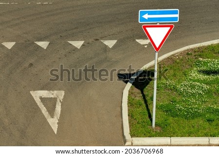 Motorway junction with sign give way on a summer day. Road traffic control markings. Royalty-Free Stock Photo #2036706968