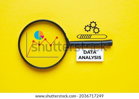 A picture of magnifying glass, graph, pie chart and data analysis word.