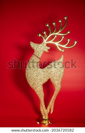 Christmas gift boxes and reindeer dolls on a red background.