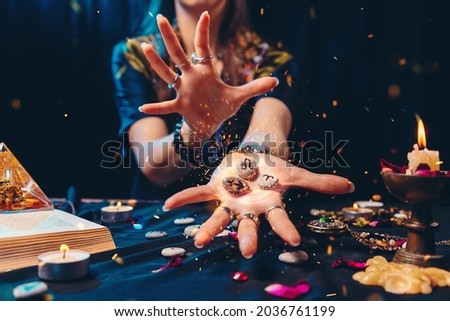 Astrology and esoterism. A sorcerer holds a flaming stones with the sign of the zodiac. Close up. The concept of horoscopes and telling. Royalty-Free Stock Photo #2036761199