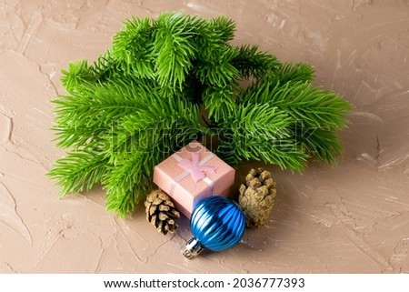 a gift in a box fir branches cones and a Christmas decoration. High quality photo