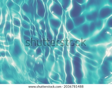Blur​ abstract​ of​ surface​ blue​ water. Abstract​ of​ surface​ blue​ water​ reflected​ with​ sunlight​ for​ background. Blue​ sea. Blue​ water.​ Water​ splashed​ use​ for​ graphic​ design.