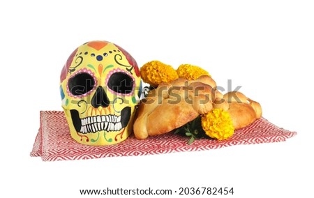 Bread of the dead and painted skull on white background. Celebration of Mexico's Day of the Dead (El Dia de Muertos)
