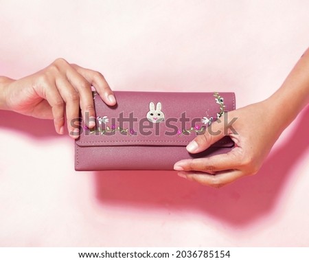 Rectangular purse with an elegant motif. Wallet to store money and cards. Simple and practical design to take anywhere. Women's wallet. Wallet mockup. Focus blur. Free space for your ad.