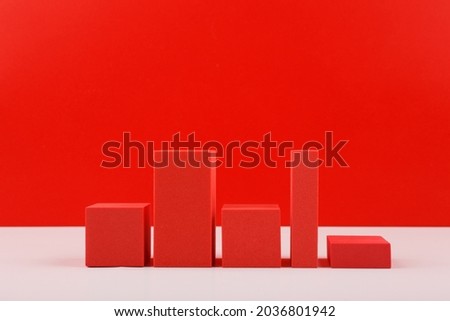 Creative business concept. Red graph diagram or perfomance chart with rise and fall dynamic against red background with copy space. Chart for marketing, annual or corporate report or profit growing