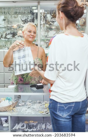 Women is shopping in a accessories boutique