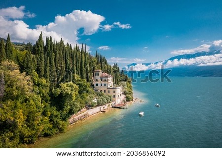 A lonely villa on the Garda Lake coast near Toscolano Maderno. Brescia province, Lombardy, Italy. Royalty-Free Stock Photo #2036856092