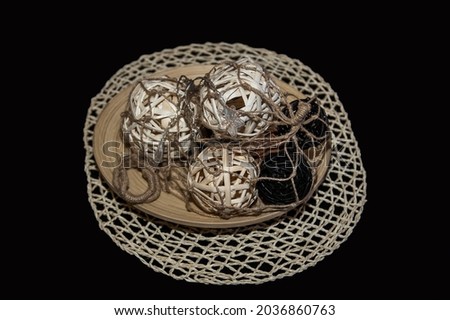 Decorative wicker balls on a wooden plate