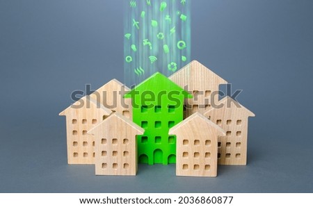 Green building stands out among the houses. Renovation and environmental improvement of old buildings. Net Zero Carbon neutrality. Environmentally friendly, energy efficient and zero emissions. Royalty-Free Stock Photo #2036860877