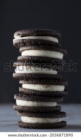Chocolate cookies with cream filling tower isolated on Black background.

G