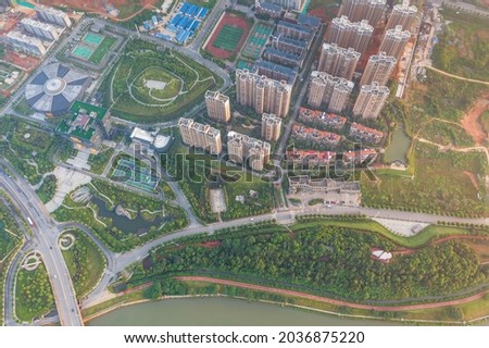 Aerial photos of industrial and residential areas near Shenzhen, China. Urban buildings surrounded by greenery.
