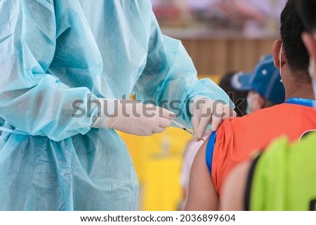 Doctor giving shot injection vaccine patient shoulder. Vaccination prevention virus covid19 pandemic