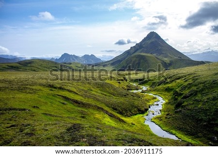 Beautiful green valley with mountains and river while trekking in Iceland Royalty-Free Stock Photo #2036911175