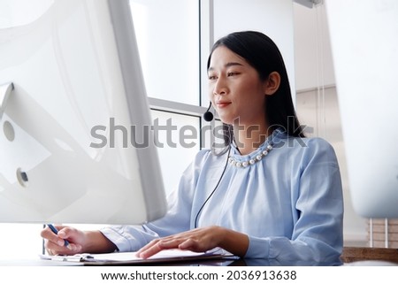 Asian woman is call center or secretary operator is talking with headset and a microphone for consultant to customers. Technician Support staff for advise and help resolve technical issues.