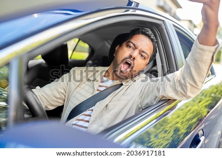 transport, vehicle and people concept - angry indian man or driver driving car and gesturing Royalty-Free Stock Photo #2036917181