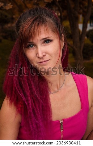 girl with dyed hair ombre in pink and in pink clothes T-shirt dress portrait autumn in warm shades Royalty-Free Stock Photo #2036930411