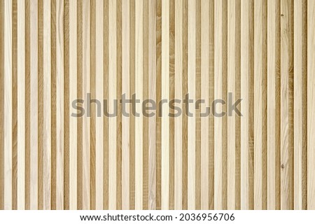 Stylish slat wood wall panel made of thin light oak planks in design light living room extreme close view Royalty-Free Stock Photo #2036956706