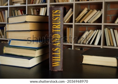 Law book about wills and trusts on the desk.