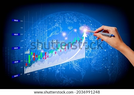 A woman's right hand poked a pen on a fast-growing stock chart. Globe background and blurred lights
