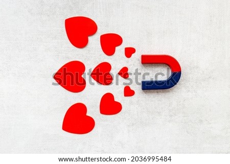 Dating love concept. Magnet with heart shapes, top view