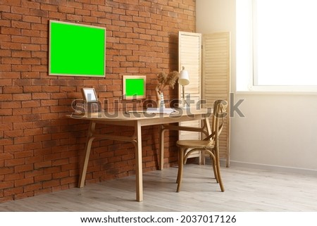 Empty photo frames on table in interior of room