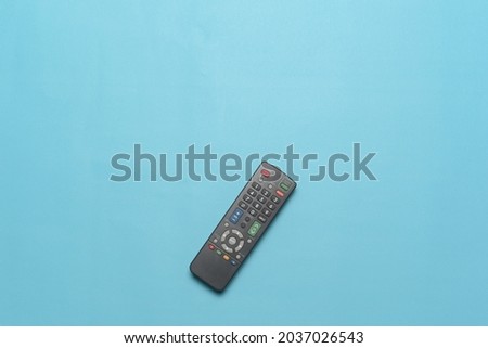 Top view of TV remote isolate on cyan background. Flatlay Photo concept