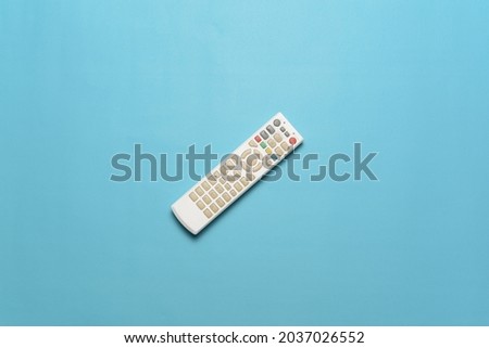 Top view of white TV remote isolate on cyan background. Flatlay Photo concept