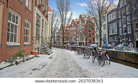 City scenic from snowy Amsterdam in winter in the Netherlands