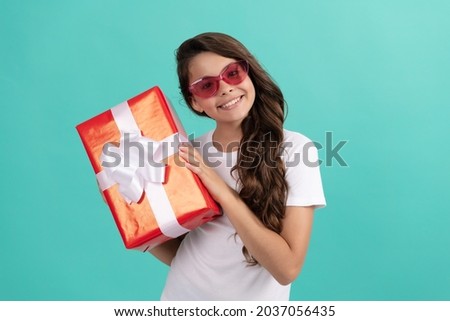 fashionable happy kid in sunglasses hold gift box, discount